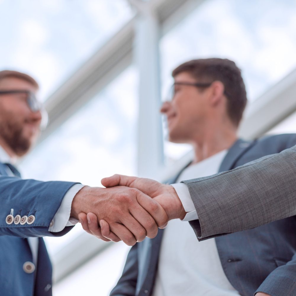 close up. background image of a business handshake in the office lobby. business background