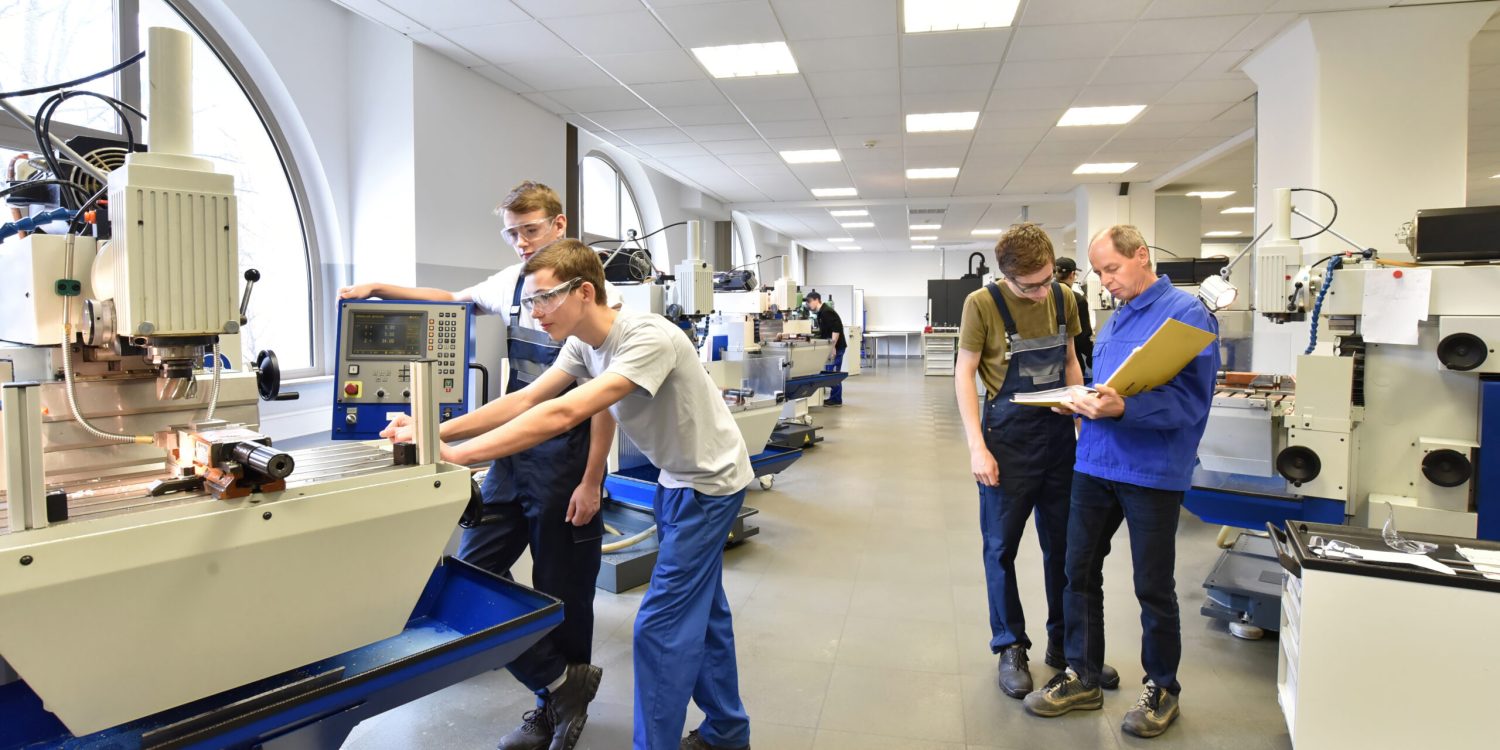 Group of young people in technical vocational training with teacher